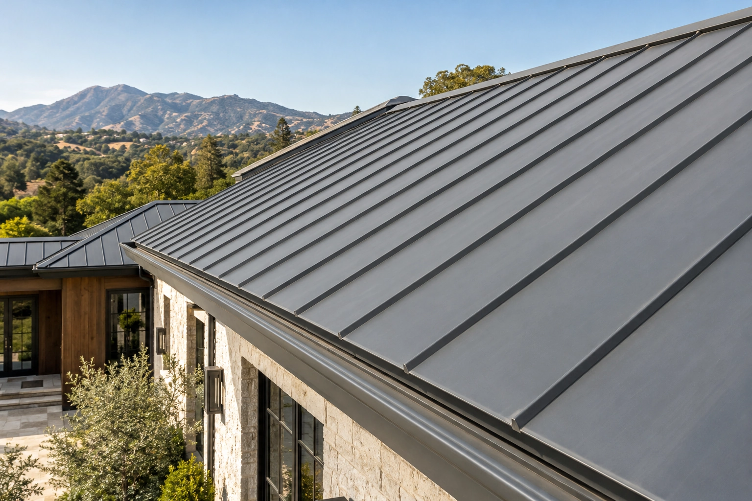 Intact standing-seam metal roof with a clear gutter and luxury stone exterior below